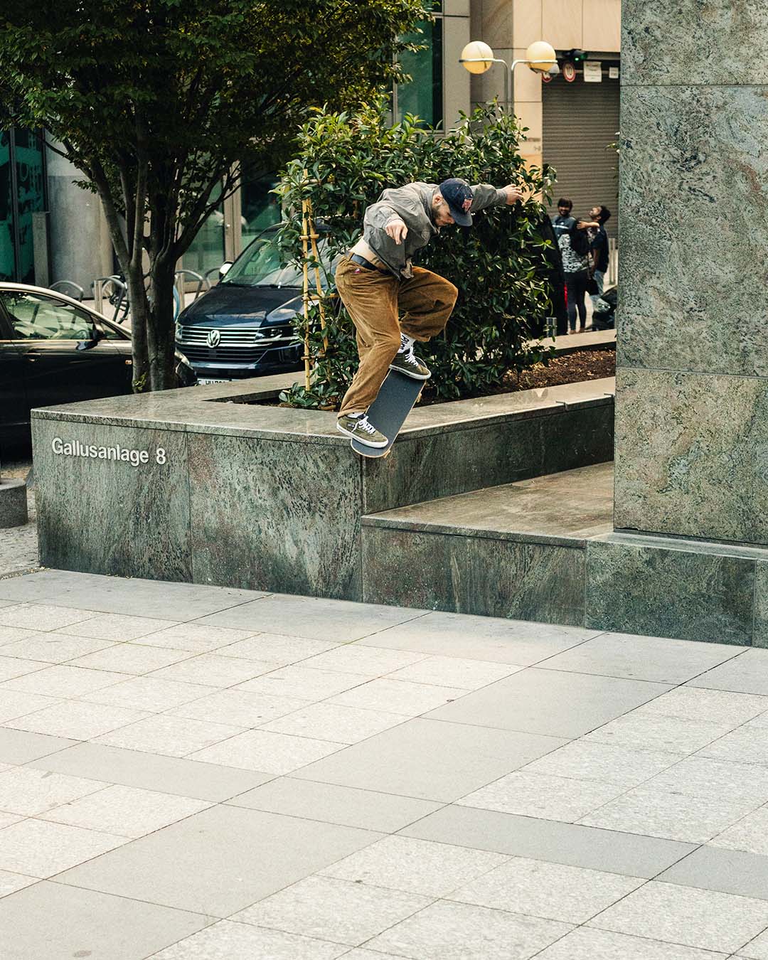 Still photography of skateboarder Lutz Schreier performing a Nosegrind on a marble low to high ledge in Frankfurt, Germany.