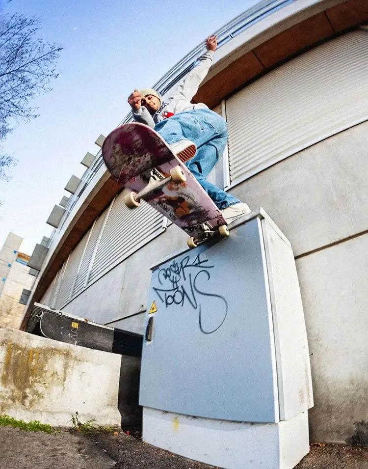Photo of a young skateboarder performing a Backside Tailslide on a junction box in the streets