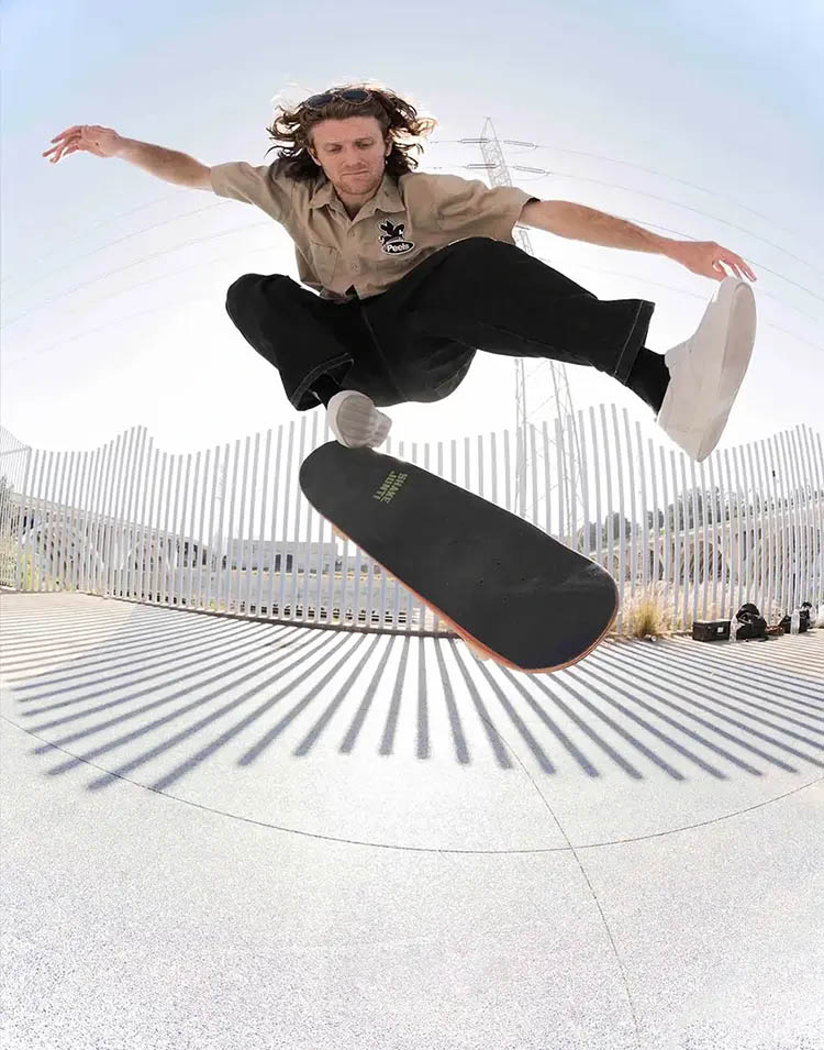 Professional skateboarder John Dilo performing a Kickflip wearing some all white HOURS IS YOURS shoes