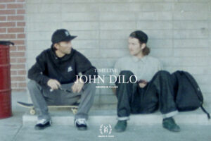 Grainy photo of two professional skateboarders Bryan Herman and John Dilo sitting on their boards and having a conversation. A serif font says in capital letters »TIMELINE JOHN DILO« and the brand’s name »HOURS IS YOURS«.