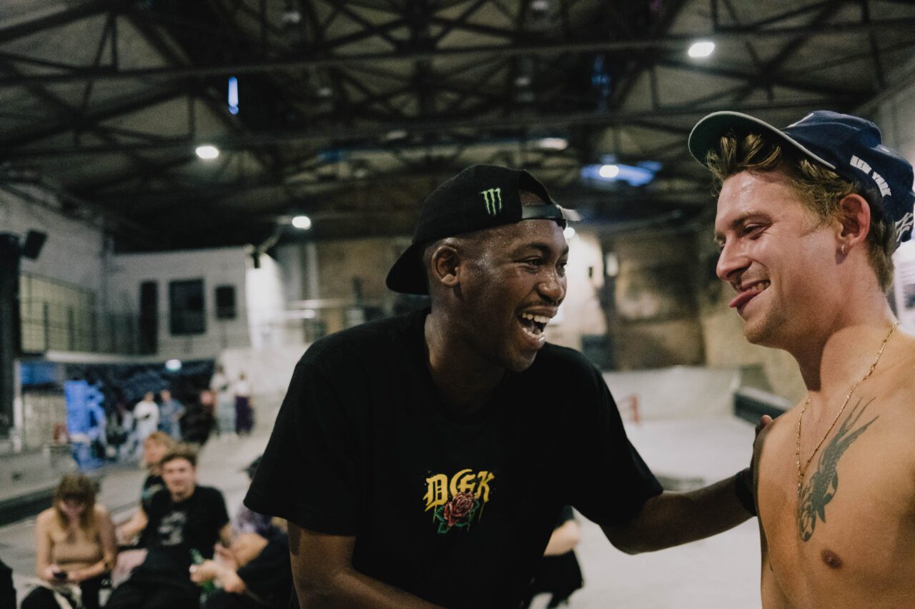 Photo showing pro skater Dlamini Dlamini and Justin Sommer, both laughing and sweating during the HUF "Forever" event.