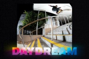 Skateboard photo of Filipe Mota performing a Kickflip Hurricane down a heave handrail. A bold neon font shows the word »DAYDREAM« in capitalized letters.